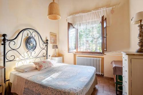 a bedroom with a bed and a window at Historic Village With Pool Near Todi in Todi