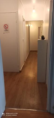 an empty hallway of an apartment with a refrigerator at Entre Ville & Nature-Sejour idéal a Massy in Massy