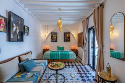 a living room with a bed and a couch at Riad NL&S Collection in Marrakech