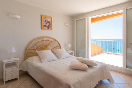 a bedroom with a bed with a view of the ocean at Seaside Villa With Panoramic Views In Les Îles D'or in La Londe-les-Maures
