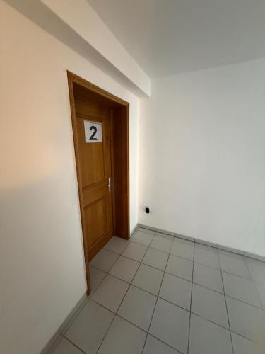 an empty room with a door with the number two at Cakir Home in Erftstadt
