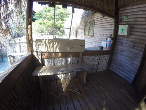 a bench sitting in the inside of a cabin at Stunning sea view, charming beach house in Barra, Mozambique - 4x4 in Miramar