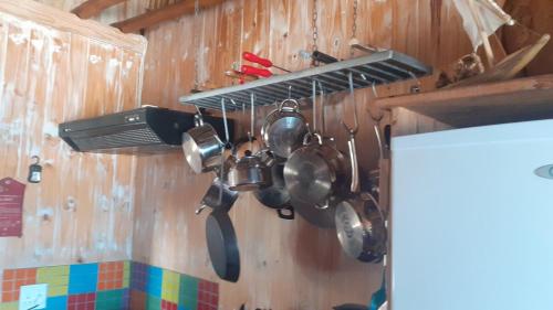 a bunch of pots and pans hanging on a wall at Stunning sea view, charming beach house in Barra, Mozambique - 4x4 in Miramar
