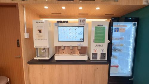 a coffee machine on a counter in a store at Shine Hotel Incheon Airport in Incheon