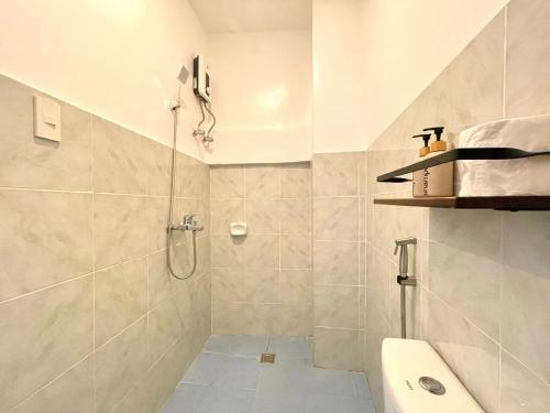 a bathroom with a shower and a toilet and a sink at Chill Out Hostel in Boracay