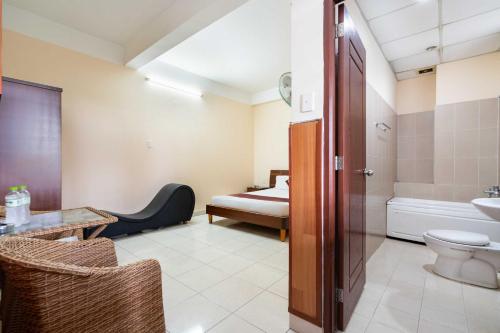 a bathroom with a bed and a toilet and a sink at Dancenter Phuong Nam Hospital Formerly Nam Phuong Hoang Hau in Ho Chi Minh City