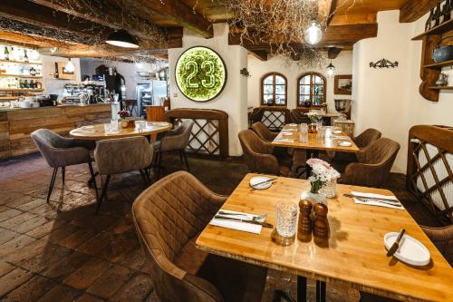 a restaurant with wooden tables and chairs at Hotel Frýdl in Prague
