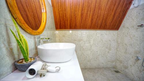 a bathroom with a sink and a plant on a counter at Jungle Crown Cabin in Sigiriya
