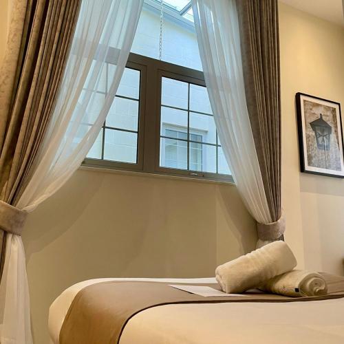 a bedroom with a bed and a window at Palazzo De La Sengle Boutique Hotel in Senglea
