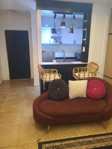 a couch with four pillows on it in a kitchen at Golden tulip apartment in Lagos