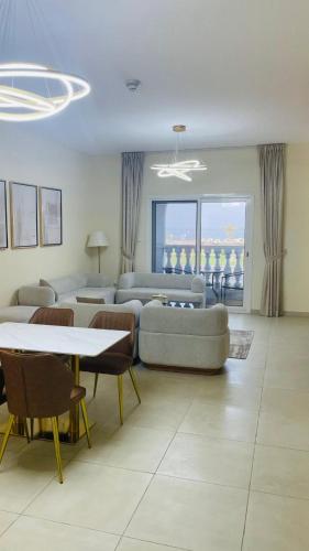 a living room with a couch and a table and chairs at sharjah,kalba 