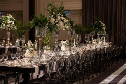 a long row of tables with glasses and flowers at Conrad Istanbul Bosphorus in Istanbul