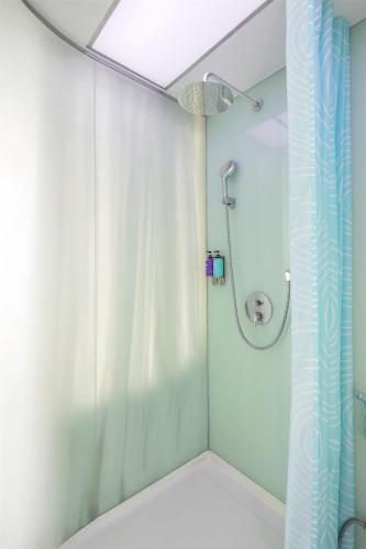 a bathroom with a shower with a shower curtain at Tru by Hilton Hanoi Station in Hanoi