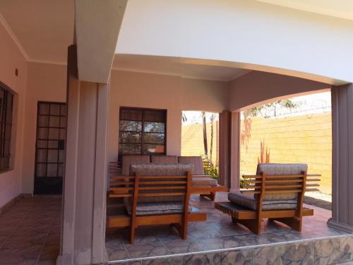 a patio with two chairs and a table at 47 The Heights, Area 47, Sector 1, Lilongwe in Lilongwe