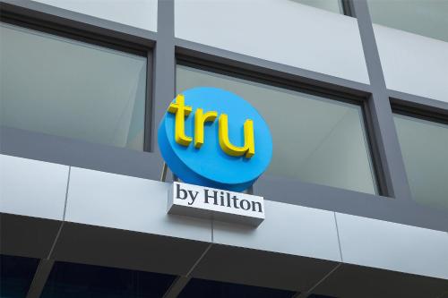 a sign on the side of a building with the ups logo at Tru by Hilton Nam Dinh City Centre in Nam Ðịnh