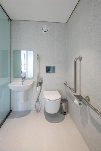 a bathroom with a toilet and a sink at Tru by Hilton Nam Dinh City Centre in Nam Ðịnh