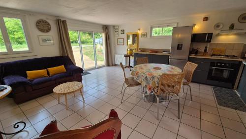 una sala de estar con un sofá y una mesa en Gîte La Salamandre au Sud de Sarlat, en Groléjac