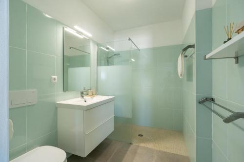 a white bathroom with a sink and a toilet at Casa Dos Amigos in Budens