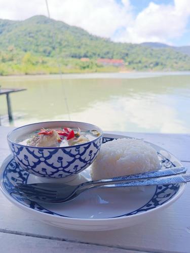 a bowl of food on a plate on a table at Sea House Koh Chang in Ko Chang