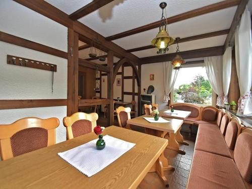 a dining room with wooden tables and chairs at Gruppen- Ferienhaus in Wieda in Wieda