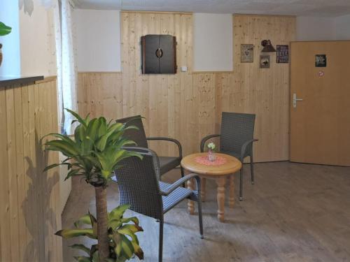 a room with chairs and a table and a door at Gruppen- Ferienhaus in Wieda in Wieda