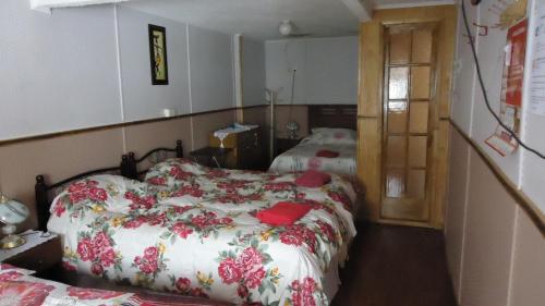 Postel nebo postele na pokoji v ubytování Hostal Patagonico