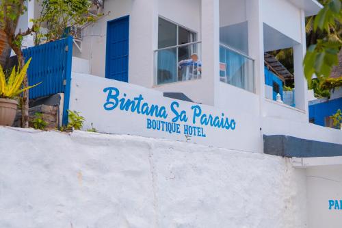 a sign on the side of a building at Bintana Sa Paraiso in Mambajao