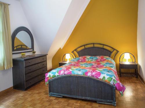 a bedroom with a bed and a dresser at Westmalle Forest Garden Home in Zoersel