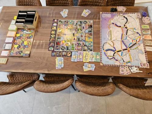 a wooden table with a boardgame at Le repaire du hibou - Piano & Spa in Petite-Rivière-Saint-François