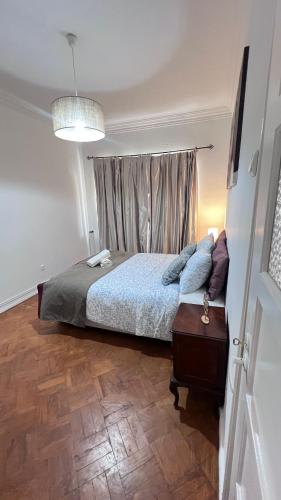 a bedroom with a bed and a wooden floor at airport room in Lisbon