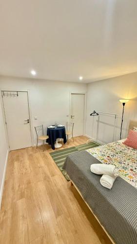 a bedroom with a bed and a table and chairs at airport room in Lisbon