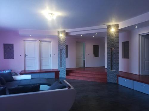 a living room with a couch and a room with lights at Designed by love in Mikepércs