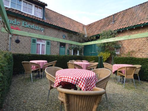 a group of tables and chairs in front of a building at Oud-Rekem Heritage Hideaway in Uikhoven