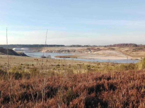 a large field with a river in the distance at Oud-Rekem Heritage Hideaway in Uikhoven