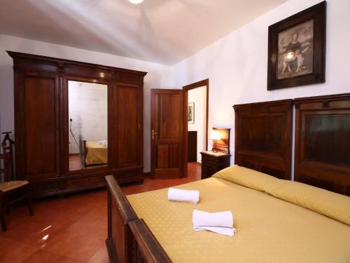 a bedroom with a bed and a mirror at Farmhouse in Umbria near Lake Trasimeno in Gualdo Cattaneo
