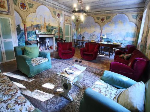 a living room with colorful chairs and a table at Farmhouse in Umbria near Lake Trasimeno in Gualdo Cattaneo