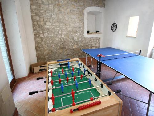 a room with a ping pong table and a table at Farmhouse in Umbria near Lake Trasimeno in Gualdo Cattaneo