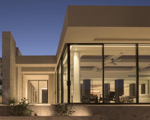 a house with large glass windows on the side of it at Fodele Beach Water Park Resort in Fodele