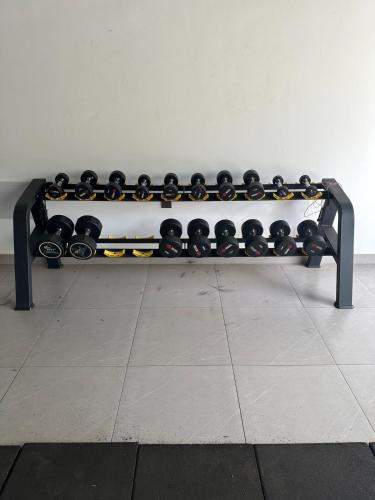 a black and white bench sitting on a tile floor at Apartment near UN,VillageMarket,breakfast,gym,pool in Nairobi