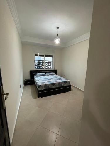 a bedroom with a bed in the middle of a room at Casa residence Khair in Tangier