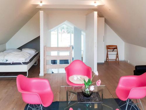 a living room with pink chairs and a bed at Secluded Retreat near Beach - By Traum Ferienwohnungen in Vigsø