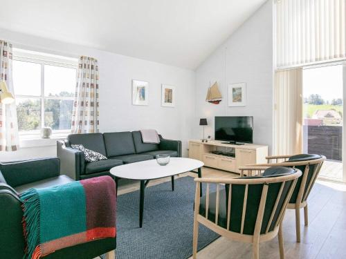 a living room with a couch and a table at Secluded Retreat near Beach - By Traum Ferienwohnungen in Vigsø