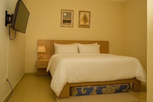 Voodi või voodid majutusasutuse Résidence La Paix Yamoussoukro, L'Oasis toas