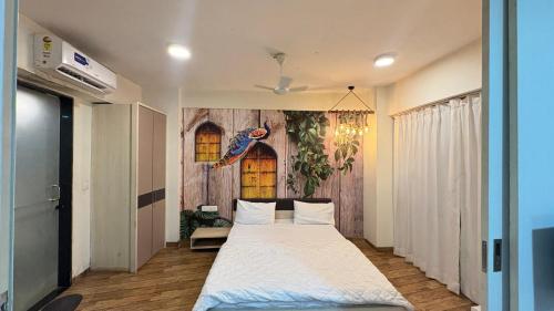 a bedroom with a large bed in a room at rajhans belliza by 7 star homes in Surat