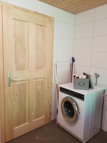 a washing machine in a room with a door at Ferien Im Gugger Wohnung Stockberg in Nesslau