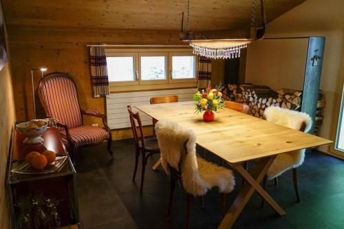 a dining room with a wooden table and chairs at Brachli in Innertkirchen