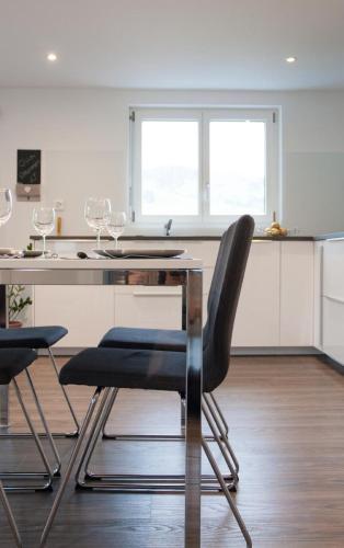 a kitchen with a table and two chairs at Ferienwohnung Brandholz in Ebnat