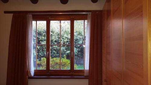 a window in a room with a curtain at Haus San Cristoforo Atelier in Maggia