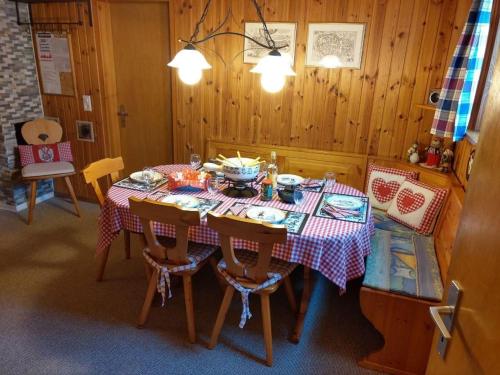 a dining room table with a red and white table cloth at Bella Vista in Sörenberg