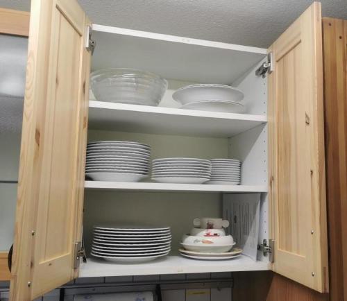 a cupboard with plates and dishes inside of it at Bella Vista in Sörenberg